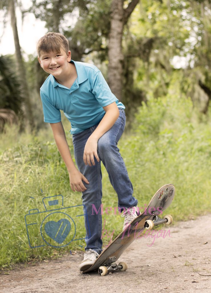 Boy with skateboard in a Central Florida Nature preserve. 