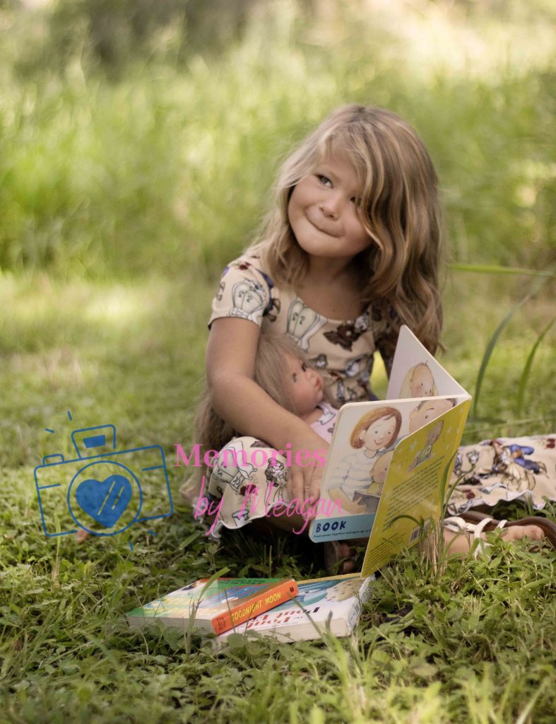 Young girl with books at a Florida nature preserve. 
